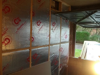 Insulation in place in wooden framework