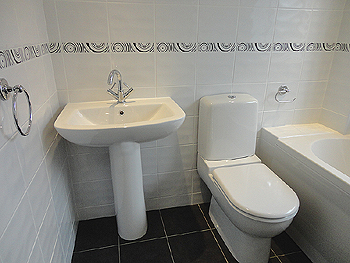The white suite with fully tiled walls and floor