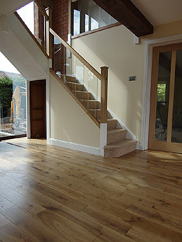 The contemporary new glass ballustrade is complemented by new oak flooring