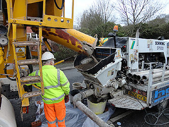 Ready mixed concrete arrives to be fed into the pump