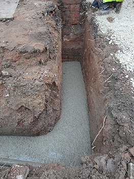 A foundation trench half-filled with concrete