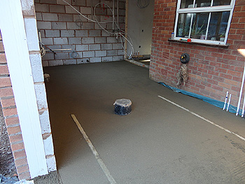 A layer of concrete is applied over the underfloor heating